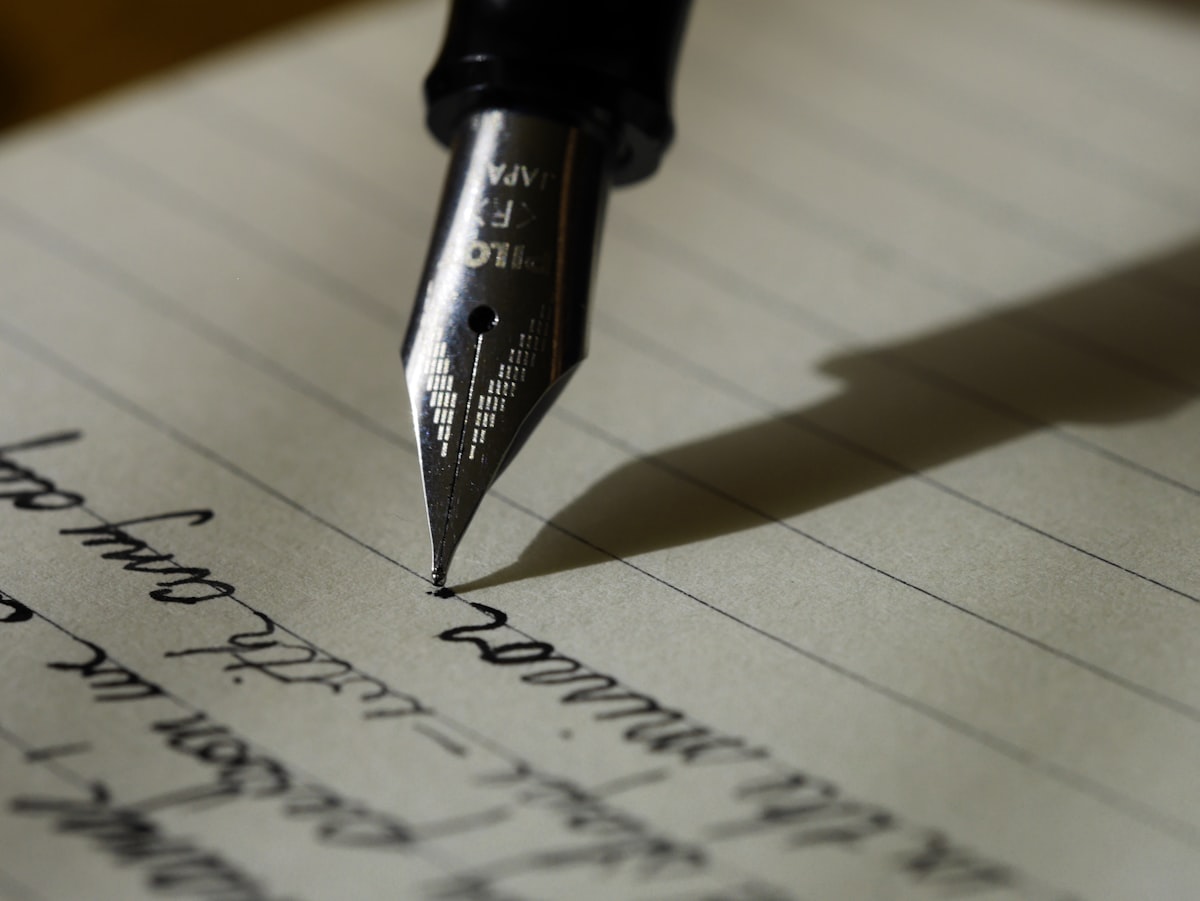 Hand writing notes in a notebook
